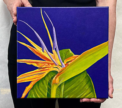 A painting, by fine artist Nancy McLennon, of a bright orange and purple 'Bird of paradise' bloom, surrounded by a deep, dark solid purple background
