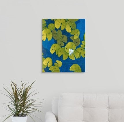 A painting, by fine artist Nancy McLennon, of a deep blue & aqua blue pond with floating golden yellow lily pads and white flower blooms hanging over a couch