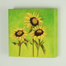 Load image into Gallery viewer, a painting by fine artist Nancy McLennon of a trio of yellow sunflowers and leaves on a warm green to yellow background sideview