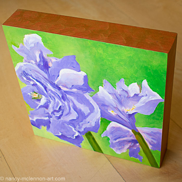 a painting by fine artist Nancy McLennon of a purple amaryllis on a warm viridian green background sideview