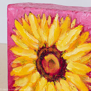 a painting by fine artist Nancy McLennon of a yellow sunflower with a brown center on ombre magenta background detail