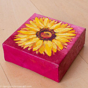 a painting by fine artist Nancy McLennon of a yellow sunflower with a brown center on ombre magenta background flatview