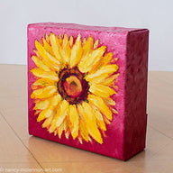 a painting by fine artist Nancy McLennon of a yellow sunflower with a brown center on ombre magenta background sideview