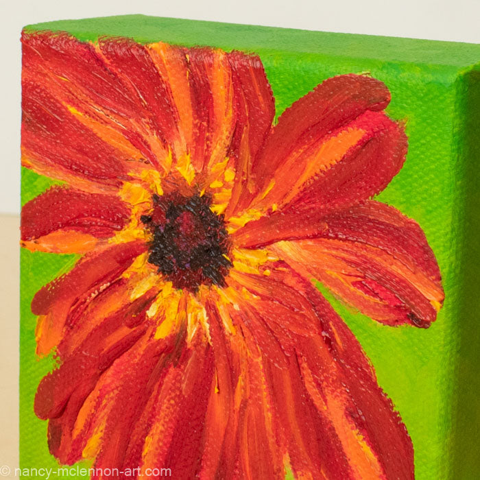 a painting by fine artist Nancy McLennon of a red gerber daisy with a brown center on a bright green background detail