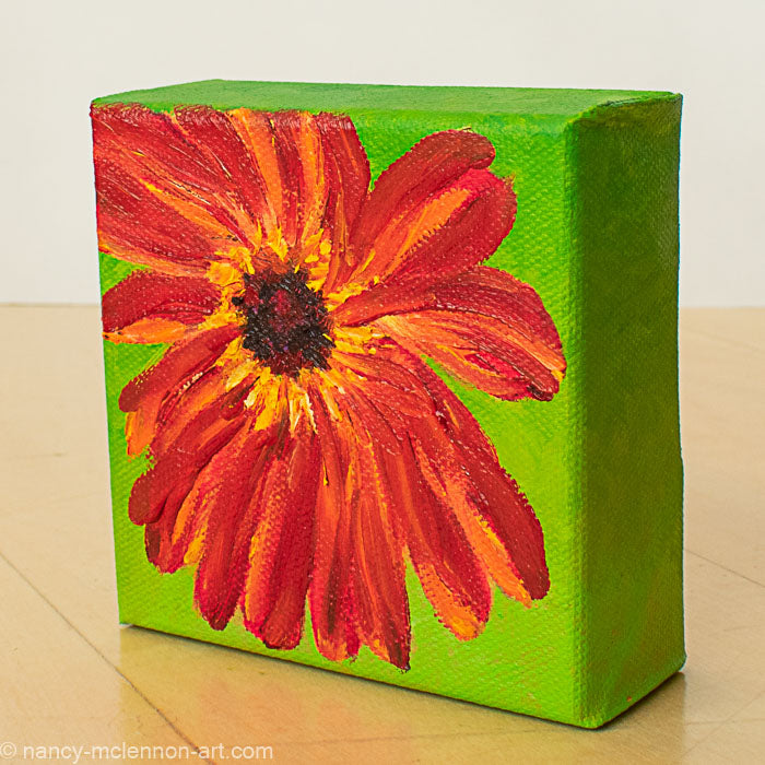 a painting by fine artist Nancy McLennon of a red gerber daisy with a brown center on a bright green background sideview