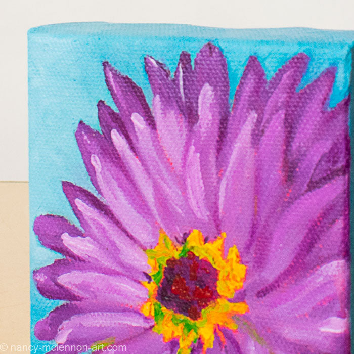a painting by fine artist Nancy McLennon of a purple gerber daisy with a yellow and brown center on a blue background detail