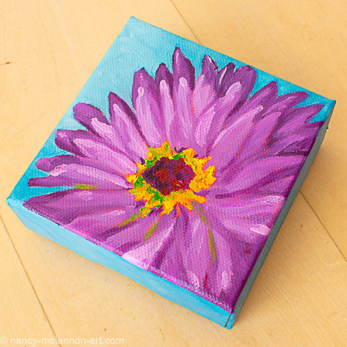a painting by fine artist Nancy McLennon of a purple gerber daisy with a yellow and brown center on a blue background overview
