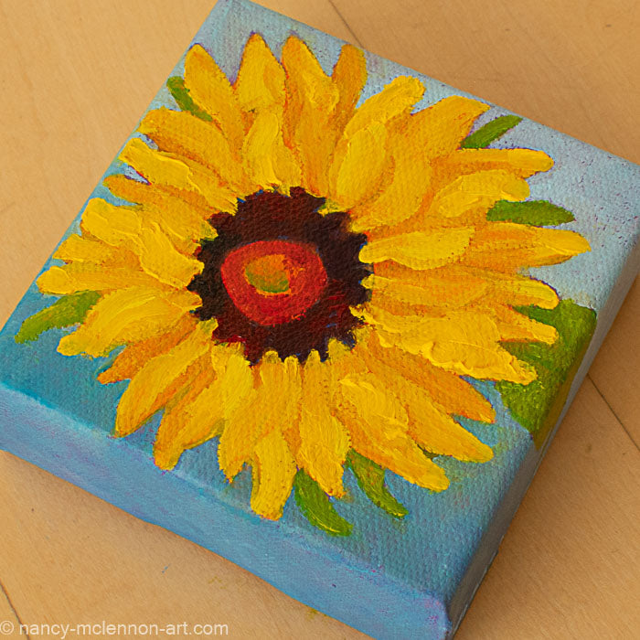 a painting by fine artist Nancy McLennon of a yellow sunflower with brown center on a blue ombre background overview