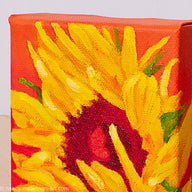 a painting by fine artist Nancy McLennon of a yellow sunflower with a red center on an orange background detail