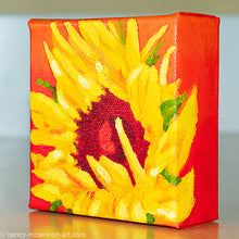 Load image into Gallery viewer, a painting by fine artist Nancy McLennon of a yellow sunflower with a red center on an orange background sideview