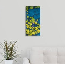 Load image into Gallery viewer, A Painting of a deep blue &amp; aqua blue pond with floating golden yellow lily pads and purple flower blooms painting hanging over a couch