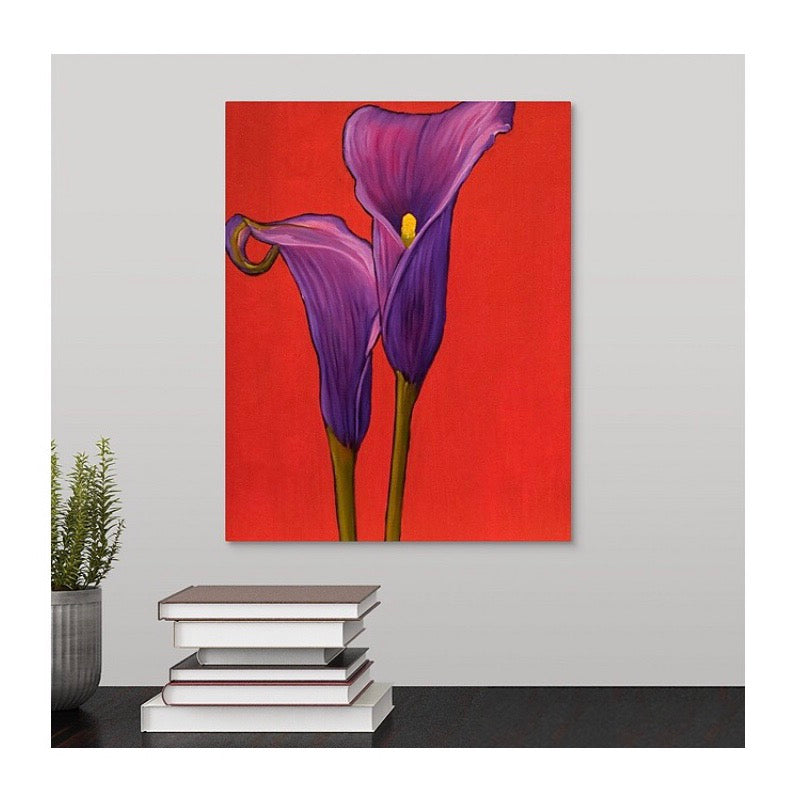 A painting by fine artist Nancy McLennon, by two deep purple calla lilies on red background hanging over a desk