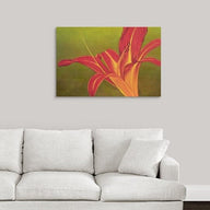 A painting, by fine artist Nancy McLennon, of a single Ruby Spider day lily on green background hanging over a couch
